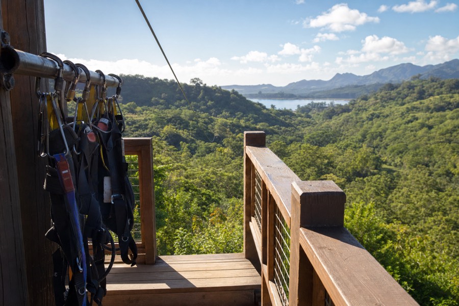 A zipline platform above a green south-shore Kauai gulch near Koloa