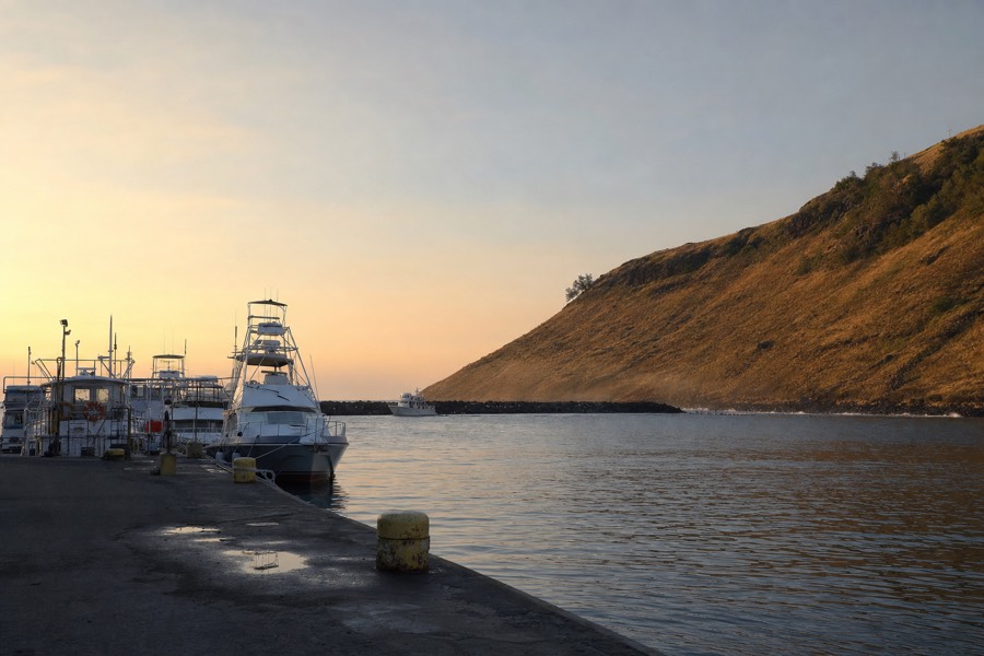Small boat harbor on Kauai's south-west coast with charter boats docked before a Na Pali cruise departure